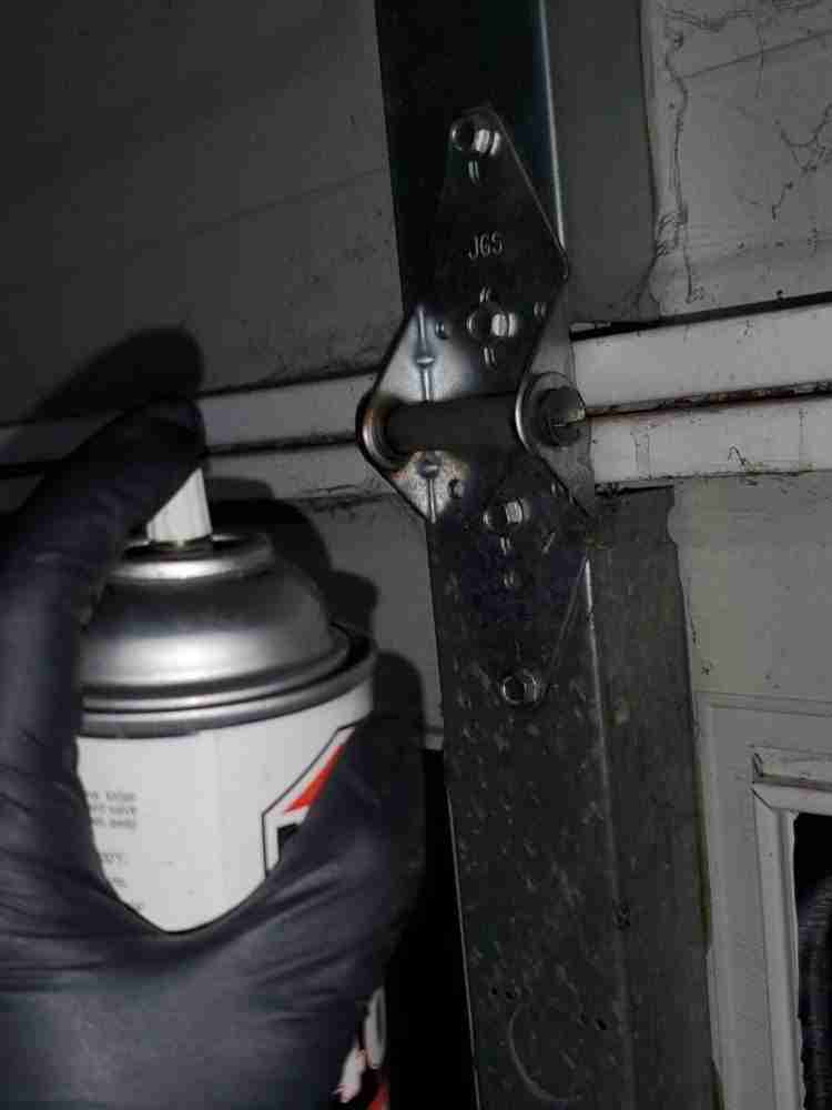 Oiling Hinges, Rollers, Torsion Springs and Bearings - Garage Door Maintenance | Family Garage Door Repair of Charlotte, NC.